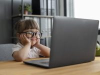 portrait-cute-girl-working-office-laptop-scaled